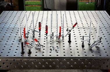 Clamping tools for welding tables